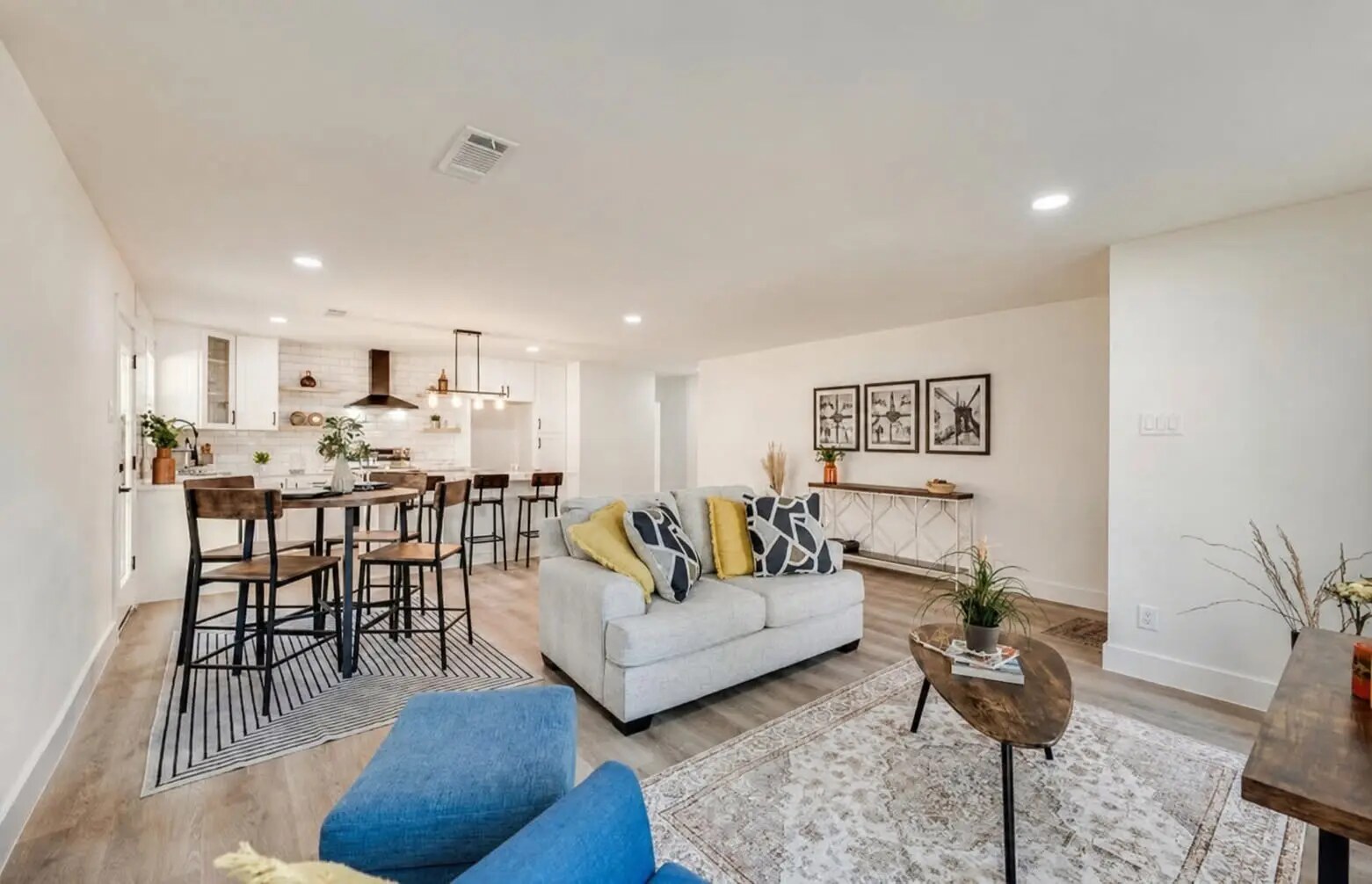Open-concept living, dining, and kitchen space staged for market