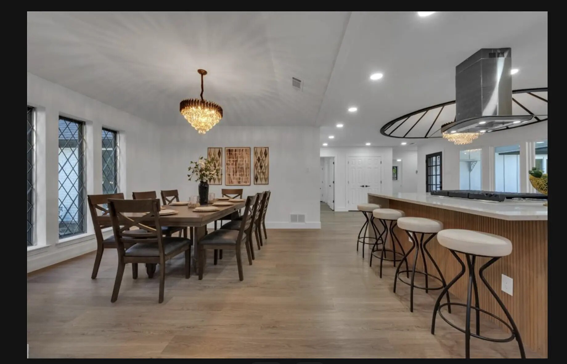 Staged dining room beside a contemporary open kitchen
