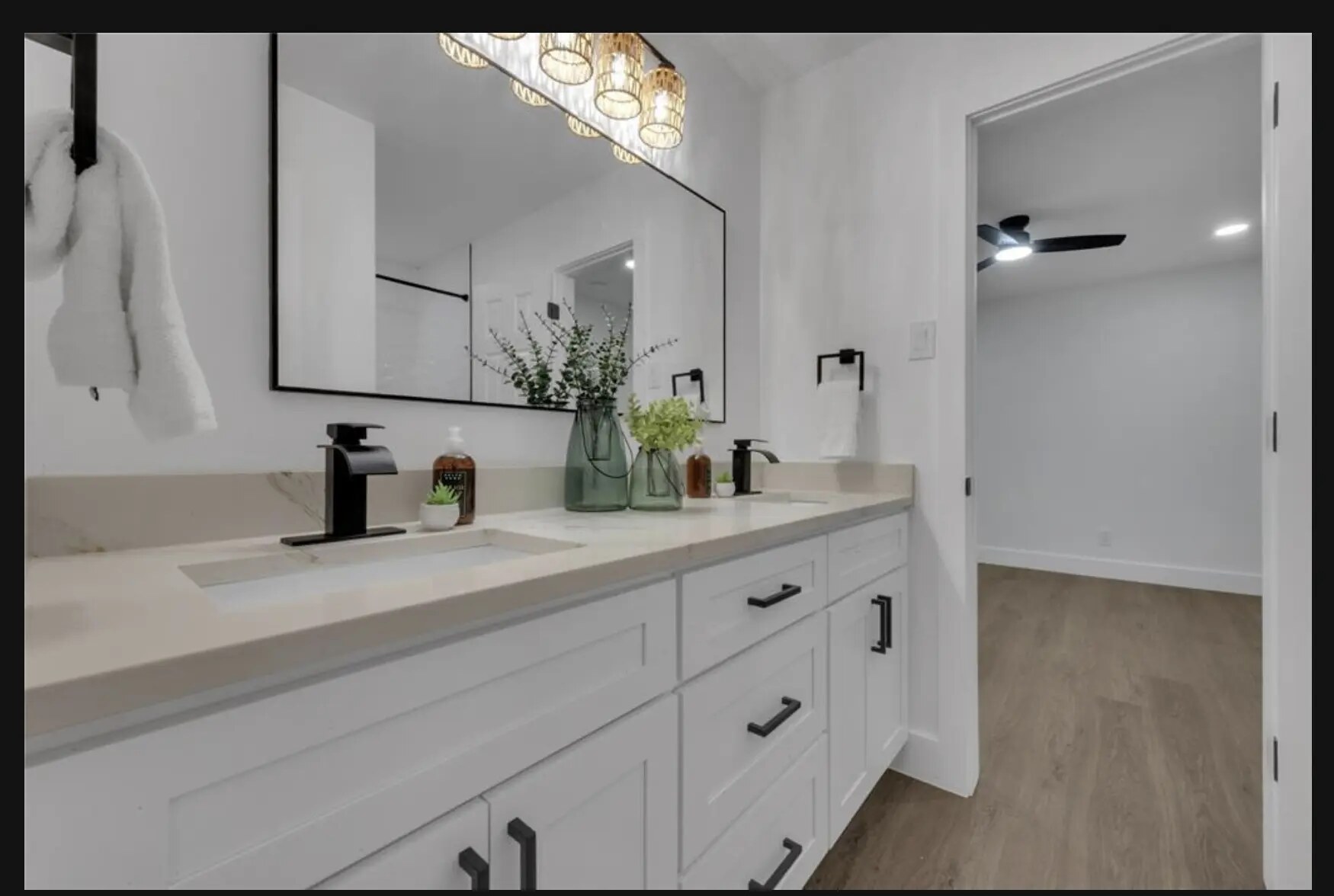 Bright double-vanity bathroom styled with greenery and neutral accents